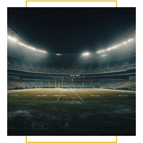 An empty, illuminated football stadium under the night sky