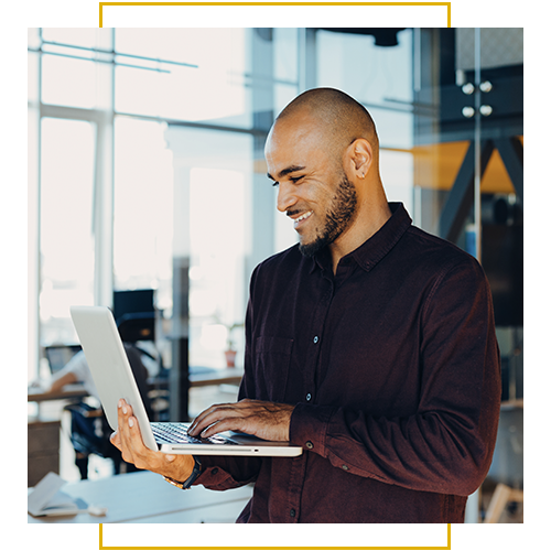 A professional works on a laptop in a modern office setting